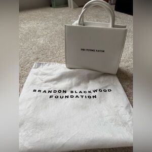 Never worn Brandon Blackwood ‘End Systemic Racism’ Mini Bag (White) with straps.